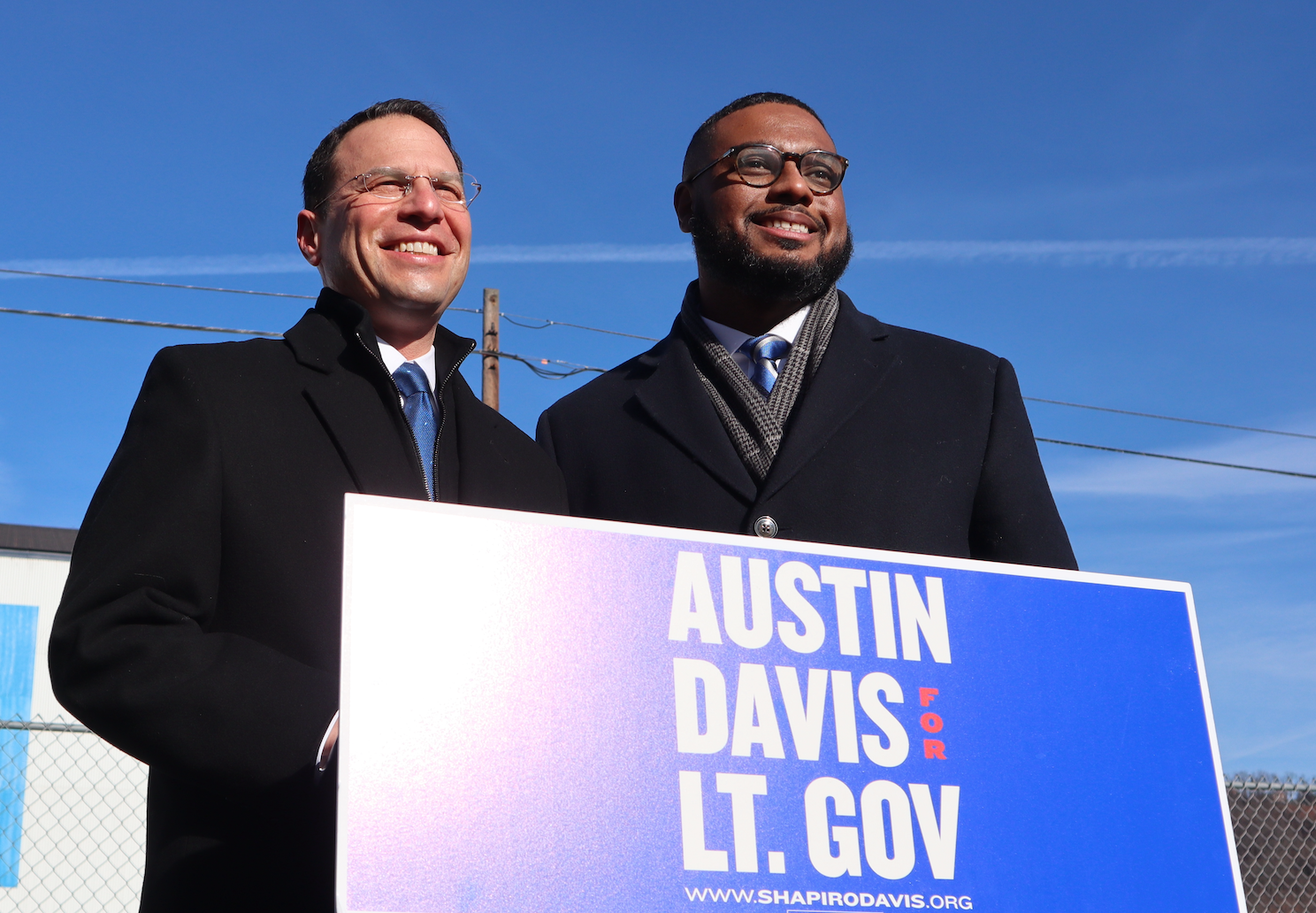 Josh and Austin smiling at a podium.