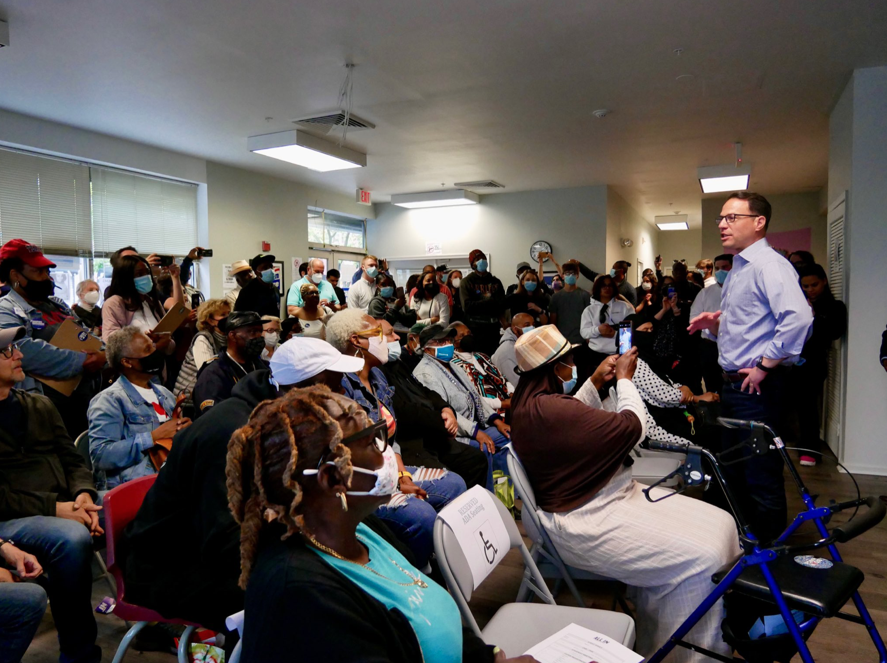 Josh gives speech in packed room.